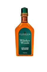 A 6-ounce bottle of Clubman Reserve Whiskey Woods After Shave Lotion featuring its whisky-colored liquid contents