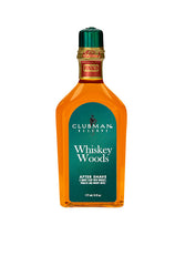 A 6-ounce bottle of Clubman Reserve Whiskey Woods After Shave Lotion featuring its whisky-colored liquid contents