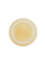 Top-down view of Tres Flores Brilliantine Pomade, highlighting its smooth, glossy texture.