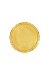 Top-down view of Tres Flores molding Pomade, showing smooth, glossy texture in jar.