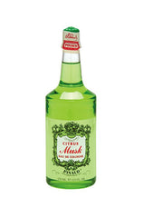 A clear 12.5 ounce bottle of Clubman Pinaud facing forward featuring its stylized label and sealed top cap