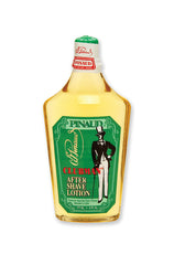 Front view of  a clear 6 ounce bottle of Clubman Pinaud After Shave Lotion showing its amber colored liquid conttents