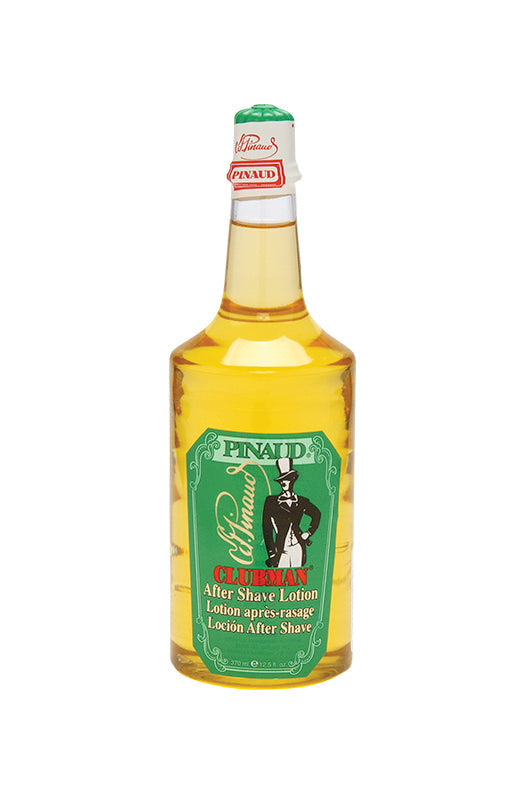 Front view of  a clear 12.5-ounce bottle of Clubman Pinaud After Shave Lotion showing its amber-colored liquid contents