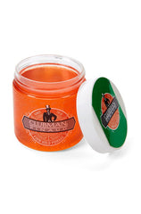 An open 4 ounce tub of Clubman Firm Hold Pomade showing its bright orange pomade contents with its lid leaning on its side